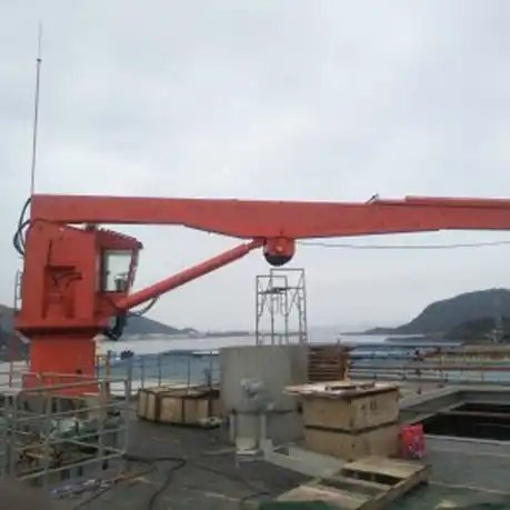 Gantry crane lifting marine hatch covers in shipyard